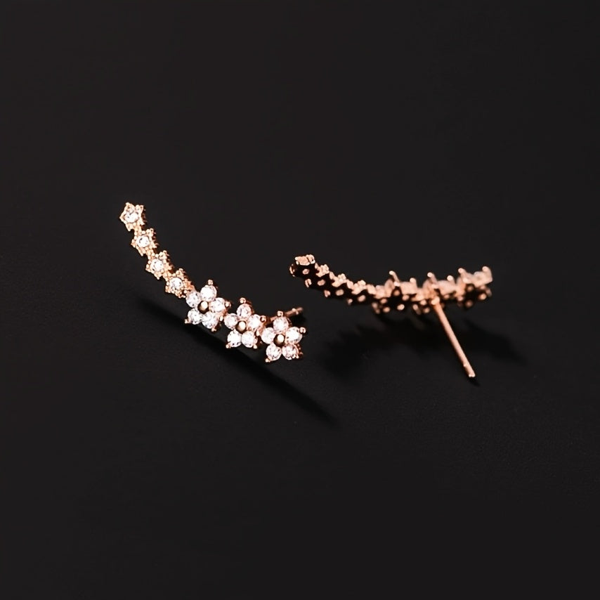 Pendientes florales tipo cadenita de pedrería, tono oro rosa, cierre de espiga