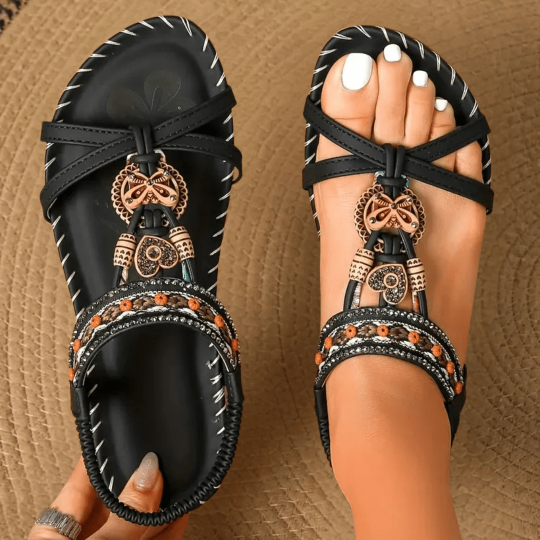 Sandalias cómodas negras con pulsera cruzada y adorno dorado colgante